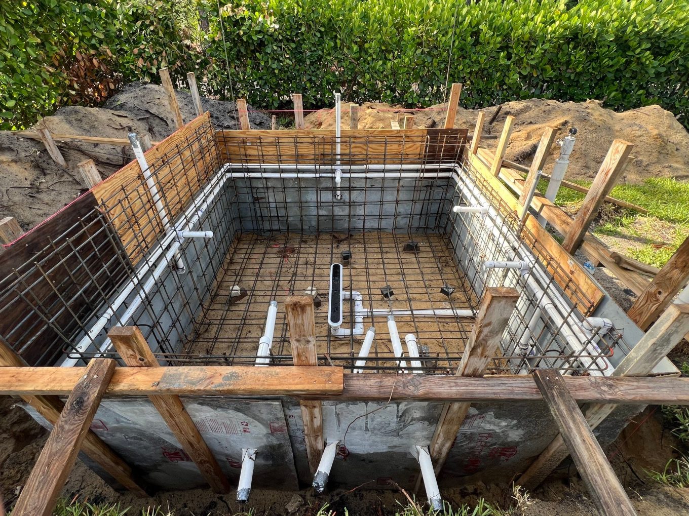 Pool layout with form boards for precise positioning in backyard
